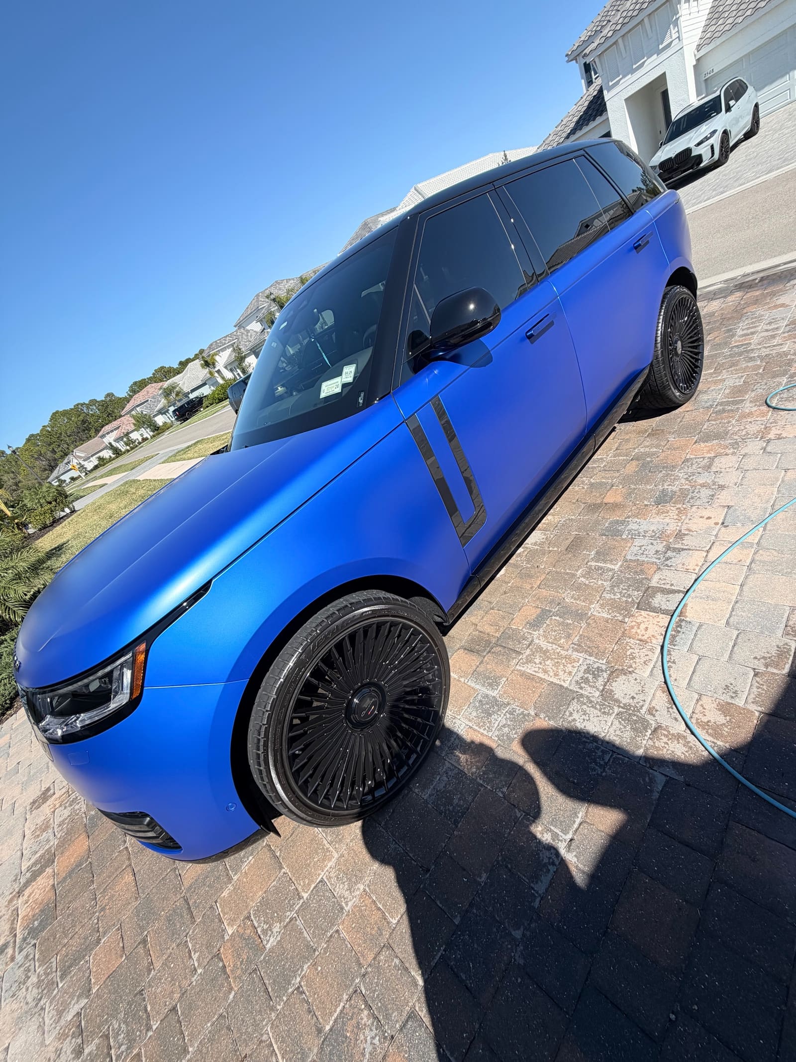 A pickup in a deep blue wrap after detailing