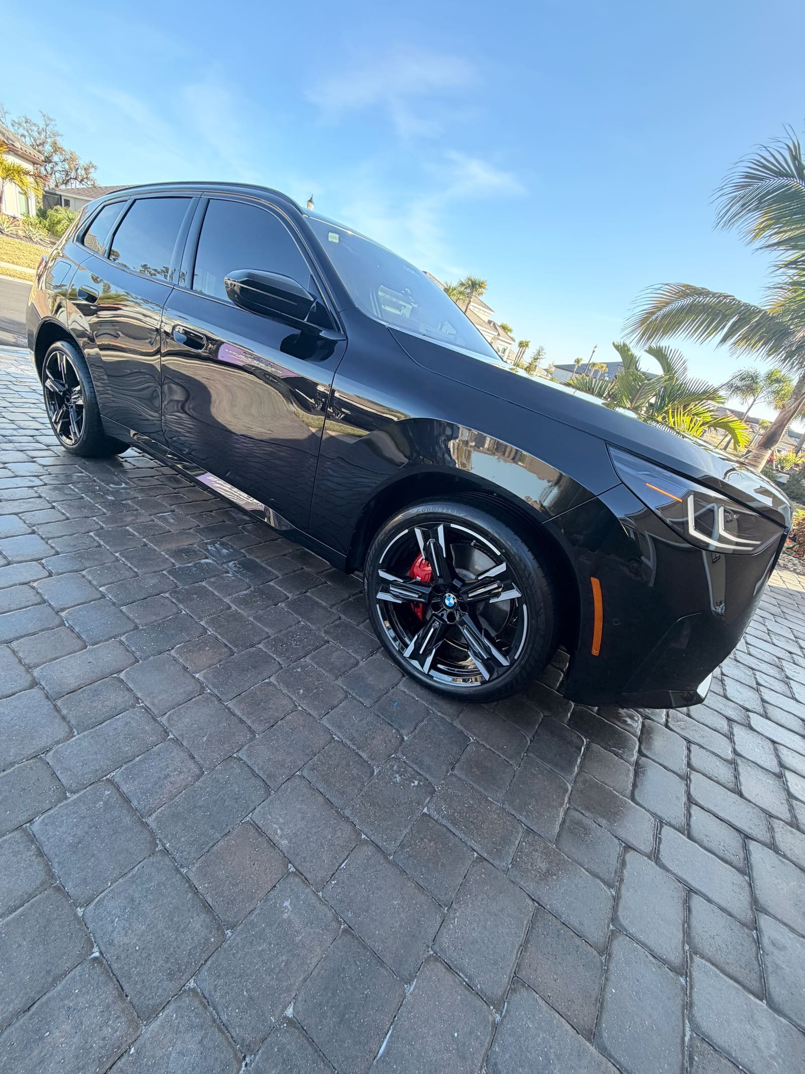 A black sedan with a deep machine-polished gloss