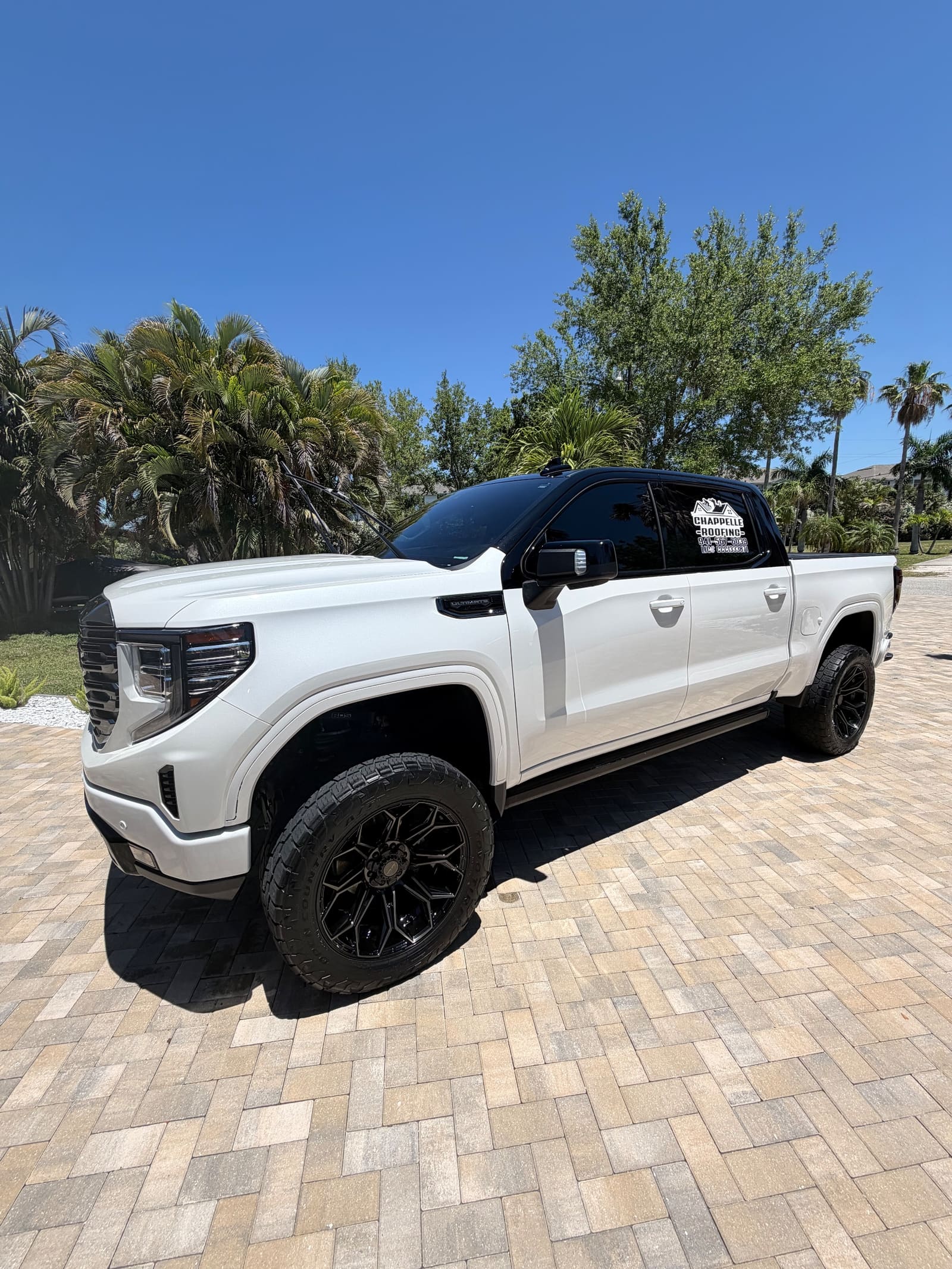 A lifted white truck after an exterior detail
