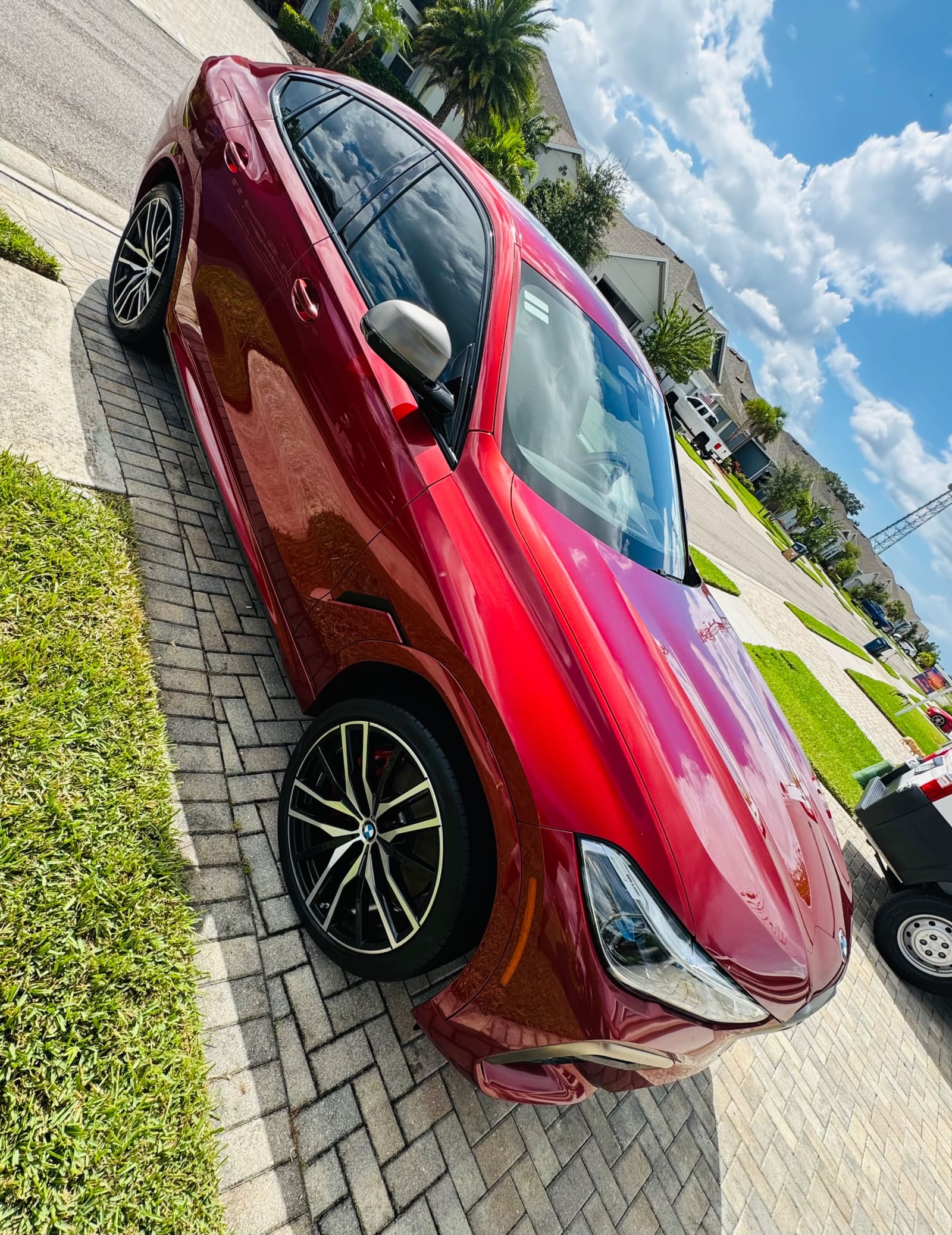 A deep red sports car with a polished finish
